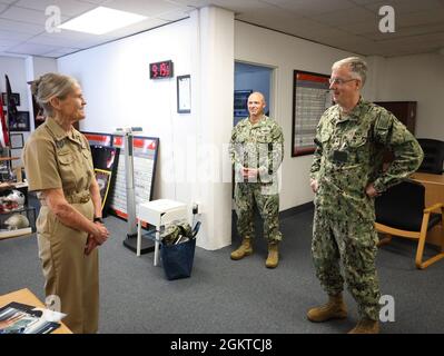 Rear Adm. Tim Weber, commander, Naval Medical Forces Pacific and director of the Navy’s Medical Service Corps (MSC), talks with retired Navy captain Mary Jo Majors during a visit to the Navy Talent Acquisition Group New England's offices, June 28. Majors, a retired Nurse Corps officer, continues to support the Navy by assisting wiht medical recruiting efforts. Stock Photo