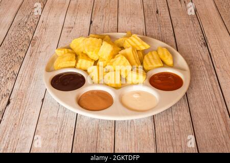 Diced potato chips with four dipping sauces Stock Photo