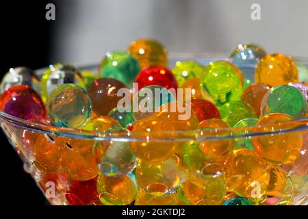 colored gel beads in close-up shot with selective focus, placed in glass container, background or texture concept Stock Photo
