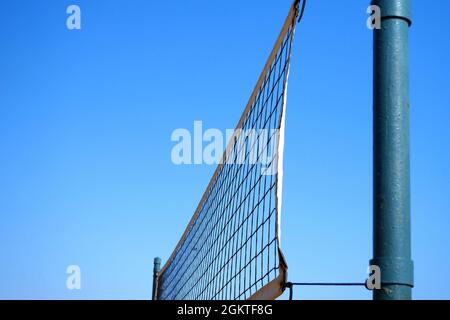 Volleyball net against blue sky. Beach volleyball equipment. Copy space. Stock Photo