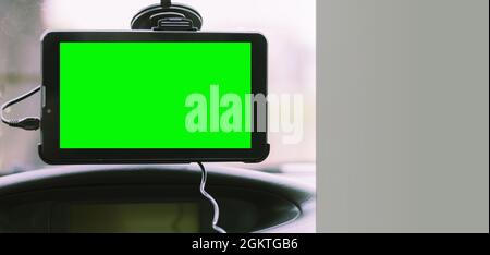 Car navigator with space for text, chroma key. Navigator on the windshield in the car Stock Photo