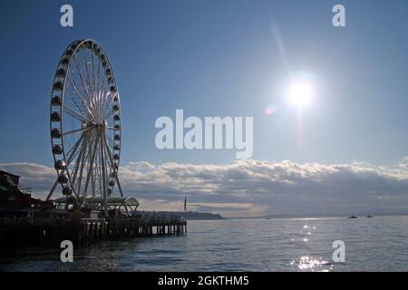 The Seattle Great Wheel with clouds during a sunny summer day in Washington state Stock Photo