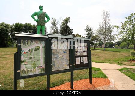 Visitor's information board with Jolly Green Giant statue in background.Green Giant Statue Park.Blue Earth.Minnesota.USA Stock Photo