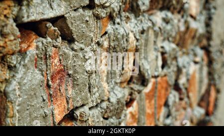 Selective focus, Freshly made Red bricks wall with concrete. This photo has been taken in India. Stock Photo