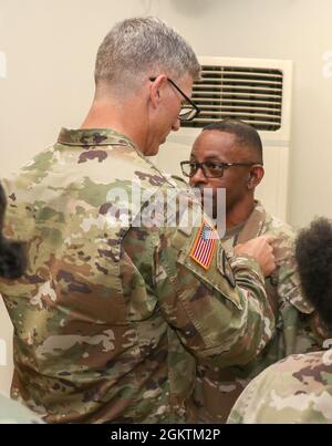 SINAI PENINSULA, Egypt - Col. Scott Sentell (left), brigade commander of Task Force Sinai, pins an award on 1st Sgt. William Bacon, Sr., currently first sergeant of Headquarters and Headquarters Company, Task Force Sinai, for Bacon's efforts during his service with the Multinational Force and Observers at an end of tour ceremony held at the South Camp, South Sinai, Egypt June 30, 2021. Stock Photo