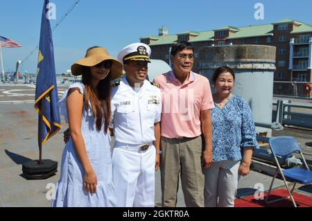 Commander Emmanuel 'Manny' Sayoc, assigned to Norfolk Naval Shipyard, poses with members of his family during his promotion ceremony on board the Battleship Wisconsin. The ceremony was hosted by the Hampton Roads Naval Museum. Stock Photo