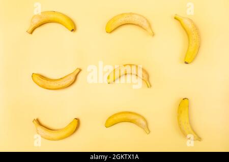 A lot of bananas to play tic-tac-toe on yellow background Stock Photo
