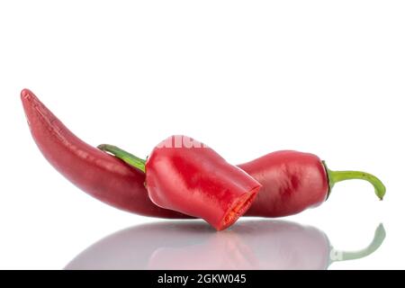 One whole and one half pod of hot red pepper, close-up, isolated on white. Stock Photo