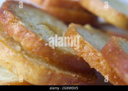 Bake rolls. Round baked bread slices. Mini bread chips close up. Stock Photo