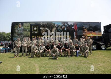 Brig. Gen. Ernest Litynski, center front, Commanding General, 85th U.S. Army Reserve Support Command, pauses for a photo with Soldiers from the U.S. Army Recruiting Battalion-Milwaukee and Appleton Recruiting Company during the Fourth of July NASCAR Cup Series race at Road America, Elkhart Lake, Wisconsin, July 4, 2021. The U.S. Army recruiting battalion, along with the Appleton Recruiting Company brought recruiters and displays from across their area to meet with citizens, allow them to experience Army technology and evaluate opportunities in military service. Litynski attended the race as th Stock Photo