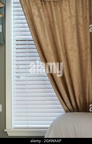 Gold Pattern Curtain on Window with White Wood Blinds Stock Photo