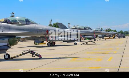 U.S. Air Force F-16 Fighting Falcons assigned to the 555th Fighter Squadron (FS) park on the flightline in preparation for Thracian Star 21 at Graf Ignatievo Air Base, Bulgaria, July 9, 2021. Eight F-16s assigned to the 555th FS are participating in Thracian Star 21, a multilateral training exercise with the Bulgarian air force, aimed to enhance the ability to rapidly deploy to remote locations and provide credible force to assure stability for the region. Stock Photo