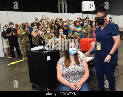 Emma L. Jenks, 21, of Millerton, NY, the daughter of Command Sergeant Major Robert Jenks, Senior Enlisted Leader New York Army National, Department of Military and Naval Affaires was selected to mark the occasion and celebrate as a team the final day of patients being vaccinated at the Jacob K Javits mass vaccination site by receiving her second Pfizer vaccination by Nurse Christina Davis-Riley, and data entry technician New York Air National Guard Tsgt Mark Manual, 137th Air Lift Wing, on July 9 at the Javits Center in Manhattan. Representatives from the various agencies that comprised Joint Stock Photo