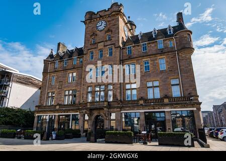 Grand Victorian building now Malmaison Hotel with clock tower on a sunny day with blue sky, Leith, Edinburgh, Scotland, UK Stock Photo