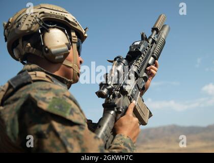 A Marine loads an M203 grenade launcher during a fire team training ...