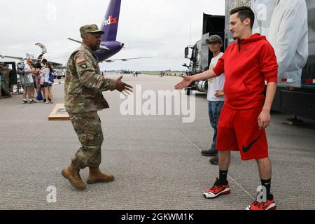 Sgt. 1st Class Seth T. Charlton, a recruiter with the U.S. Army Recruiting Station in Dayton, Ohio, introduces himself to civilians during the 2021 Centerpoint Energy Dayton Air Show July 11 at the Dayton International Airport. The 46th annual event, headlined by the U.S. Air Force Thunderbirds and U.S. Army Golden Knights, allowed civilians to interact with service members and support Dayton’s biggest celebration of aviation. Stock Photo