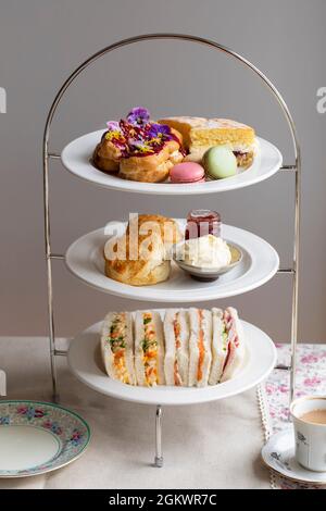 Afternoon tea with cakes, scones and macaroons Stock Photo