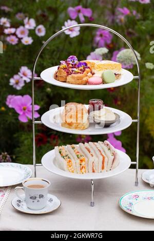 Afternoon tea with cakes, scones and sandwiches Stock Photo