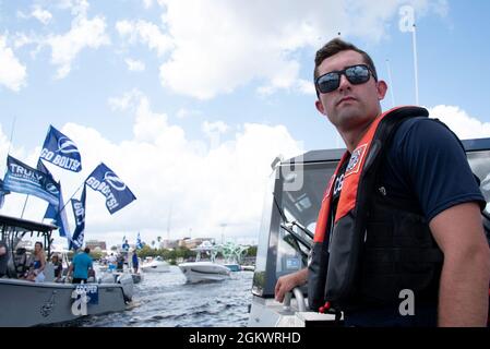 Coast Guard Petty Officer 3rd Class Gage Hunnicutt, a machinery technician, scans the waterway during Tampa Bay Lightning’s Stanley Cup Championship Boat Parade, Tampa, Florida, July 12, 2021. The Coast Guard collaborated with its interagency partners on the patrol to provide security, ensure the movement of vessels in the parade, and keep the boating public safe during the celebration. Stock Photo