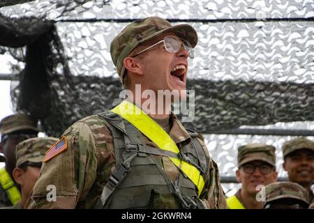 Jeremy Rief, University of Wyoming, calls his Platoon to attention during Charlie and Delta Companies motivational showdown prior to beginning the Buddy Land Navigation event at Fort Knox, Ky., on July 12, 2021. Cadre holds this motivational exercise prior to the start of the event to raise moral and help Cadets control their nerves. | Stock Photo