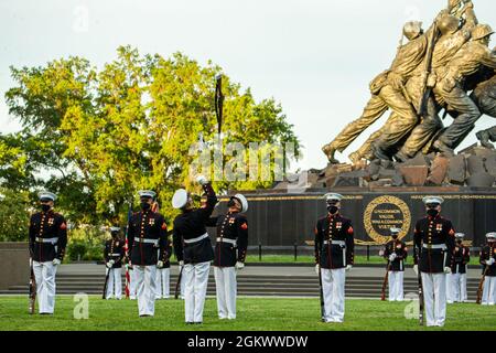 Marines with the Silent Drill Platoon execute their “rifle inspection” sequence during the Tuesday Sunset Parade at the Marine Corps War Memorial, Arlington, Va., July 13, 2021. The hosting official for the evening was Brig. Gen. George B. Rowell IV, Director of Communication, Headquarters, Marine Corps, and the guest of honor was Vice Admiral Sean Buck, Superintendent of the United States Naval Academy. Stock Photo
