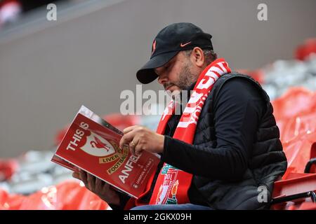 A Liverpool reads todays match day program Stock Photo