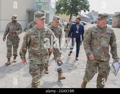 Maj. Gen. Douglas A. Sims II (left), commander of the 1st Infantry Division, is briefed by Capt. Josh Gross (right), a division engineer with the 1st Infantry Division Forward before the official transfer of authority ceremony at Forward Operating Site Poznań, in Poznań, Poland, July 14, 2021. The transfer marks the beginning of the 1st Infantry Division’s second rotation to Poland in support of Atlantic Resolve. Atlantic Resolve builds readiness, increases interoperability and enhances the bond between ally and partner militaries using multinational training events. Stock Photo