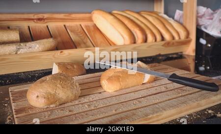 Bread loafs at wooden cutting board Stock Photo