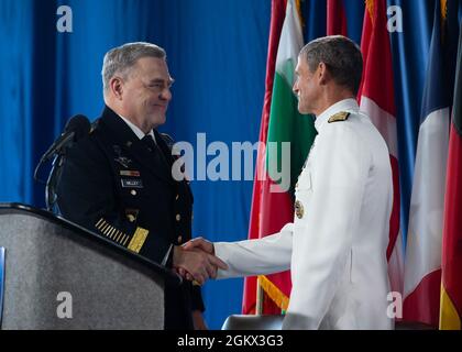 NORFOLK, Va. (July 15, 2021) – Gen. Mark Milley, Chairman of the Joint Chiefs of Staff, and Vice Adm. Andrew Lewis, Commander, Joint Force Command (JFC) Norfolk, shake hands during the ceremony to declare JFC Norfolk’s Full Operational Capability aboard amphibious assault ship USS Kearsarge (LHD 3) on July 15. JFC Norfolk stands as an operational embodiment of the Trans-Atlantic Bridge. JFC Norfolk will continue to maintain security of the strategic lines of communication between Europe and North America and provide deterrence to any potential adversary. Stock Photo