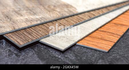 PVC vinyl floor. Samples of vinyl flooring. Collection of vinyl tiles. DIY home items Stock Photo