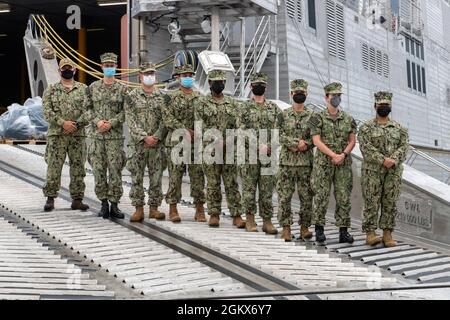 MANILA, PHILIPPINES (July 14, 2021) - The Pacific Partnership 2021 team, led by Capt. Jesus Rodriguez, disembark the Spearhead-class expeditionary fast transport USNS City of Bismarck (T-EPF-9). City of Bismarck is serving as the mission platform for Pacific Partnership 21. Pacific Partnership, now in its 16th iteration, brings nations together to prepare during calm periods to effectively respond in times of crisis. Each year, the mission team works collectively with host and partner nations to enhance regional interoperability and disaster response capabilities, increase security and stabili Stock Photo