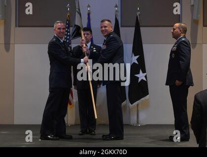 Col. Richard Bourquin, outgoing Space Delta 4 commander, passes the guidon to Lt. Gen. Stephen Whiting, Space Operations Command commander, during a change of command ceremony at Buckley Space Force Base, Colo., July 15, 2021. The passing of the guidon is a military tradition that symbolizes a transfer of command and commemorates past leadership and success of the outgoing commander. Stock Photo