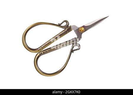 Small golden old fashioned sewing scissors isolated on white background Stock Photo