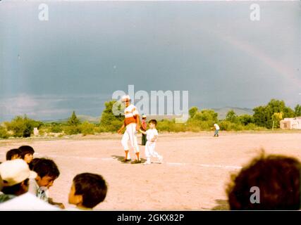 Baseball: 790716-A- UJ420-1002  Fort Bliss Garrison Command Sgt. Maj. Gerardo Gonzalez, at 5-years-old, sick with fever walks off the baseball field with his dad, in Julimes Chihuahua, Mexico, summer 1979. Stock Photo