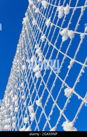 Volleyball net covered with snow. Nature's minimalism.  Stock Photo