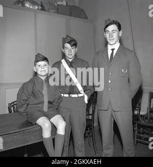 1966, historical, the Boys Brigade, three boys wearing their BB uniforms, Fife, Scotland, UK. Founded as a Christian youth movement in Glasgow, Scotland in 1883 by William Alexander Smith, the idea of a uniformed youth group was a new idea at that time. The picture here shows three boys of different ages wearing redesigned BB uniform. All three with the traditional BB cap, but only the boy in the middle wearing the belt. At this time, the Brigade reorganised the Junior Section, formerly known as The Life Boys, A new Junior Section Achivement Scheme was introduced. Stock Photo