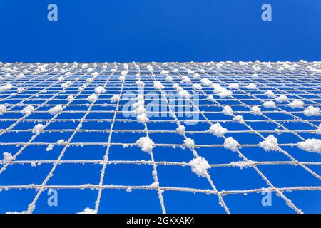 Volleyball net covered with snow. Nature's minimalism.  Stock Photo