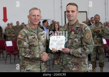 U.S. Army Maj. Gen. Douglas A. Sims II (left), 1st Infantry Division commanding general, and Col. Bryan Chivers, 1st Combat Aviation Brigade commander, pose for a photograph before a change of command ceremony at Illesheim Army Airfield, Germany, July 17, 2021. Sims had just awarded Chivers the Legion of Merit. The 1st CAB is on a rotational deployment to Europe in support of Atlantic Resolve. Atlantic Resolve maintains a rotational forward presence throughout Europe and enables deterrence and defense against threats from any direction at any time. Stock Photo