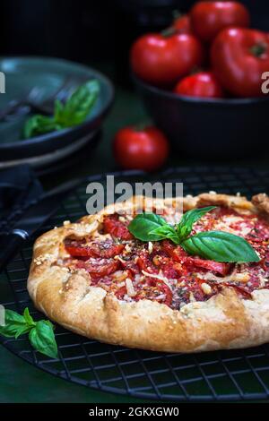 Delicious homemade rustic tomato and cheese open pie (galette) Stock Photo