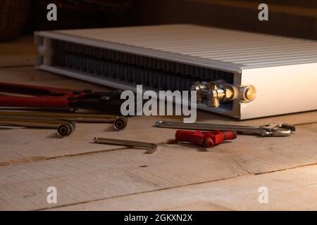 steel radiator and assembly tool. Heating repair concept. Stock Photo