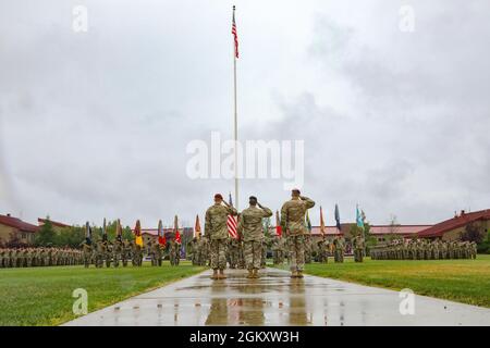 Maj. Gen. Brian Eifler, Commanding General USARAK (Incoming), left, Maj. Gen. Xavier Brunson, Commander I Corps, center, Maj. Gen. Peter Andrysiak, Commanding General USARAK (Outgoing), right, salute the US Flag during the Change of Command ceremony on Pershing Field at Joint Base Elmendorf-Richardson July 21. Stock Photo