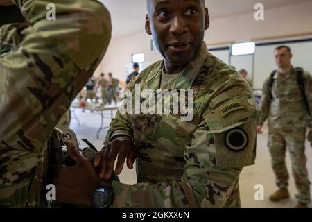 Maj. Gen. Xavier T. Brunson, commander of I Corps, Washington, inspects a paratrooper’s parachute during his visit to the 4th Infantry Brigade Combat Team (Airborne), 25th Infantry Division, US Army Alaska, at Joint Base Elmendorf-Richardson, July 22, 2021. The 4th IBCT (ABN), 25th ID is the US Army’s only Arctic airborne brigade and is the leading edge of the developing Arctic strategy. Stock Photo