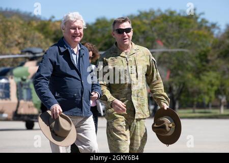 His Excellency the Honourable Paul de Jersey Companion of the Order of Australia, Commander of the Royal Victorian Order, Governor of Queensland (left), and Australian Army Lt. Gen. Greg Bilton, Chief of Joint Operations (right), walks to greet U.S. military service members and Australian Defence Force personnel during Exercise Talisman Sabre 21 at Lavarack Barracks in Townsville, Queensland, Australia, July 26, 2021. The Governor's role encompasses a wide range of important duties and responsibilities including Constitutional and legal - such as appointing Ministers of the Crown and summoning Stock Photo