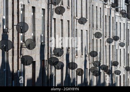 Satellite dishes on front of tenement buildings on Esslemont Avenue, Aberdeen, Scotland, UK Stock Photo
