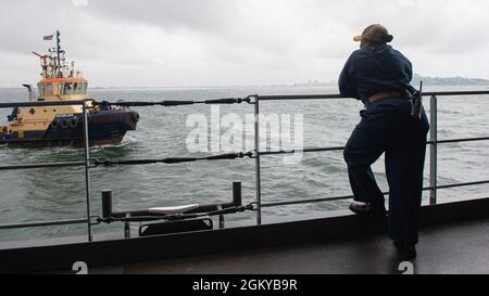 210727-N-LK647-0149 MONROVIA, Liberia (July 27, 2021) Executive Officer Ernique Sesler watches a Liberian tug boat approach the Expeditionary Sea Base USS Hershel 'Woody' Williams (ESB 4), July 27, 2021. Hershel 'Woody' Williams is on a scheduled deployment in the U.S. Sixth Fleet area of operations in support of U.S. national interests and security in Europe and Africa. Stock Photo