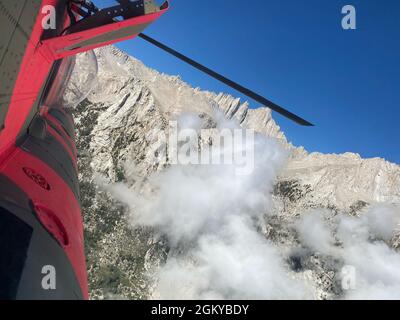 A U.S. Army CH-47F Chinook helicopter from the California Army National Guard’s Army Aviation Support Facility in Stockton, California, flies near Mt. Whitney in Inyo County, July 27, 2021, during a search and rescue mission for three hikers who were stranded above 12,600 ft. overnight with little to no supplies. The mission was flown in support of Inyo County Sheriff’s Office via the California Governor’s Office of Emergency Services. Stock Photo