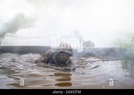 A U.S. Marine Corps officer candidate with India Company navigates through the Combat Course at Officer Candidates School on Marine Corps Base Quantico, Virginia, July 29, 2021. The Combat Course simulates an environment that may be encountered on the battlefield. During the course, candidates are evaluated in individual tactics while negotiating obstacles. Stock Photo
