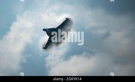 A U.S. Navy Electronic Attack Squadron (VAQ) 129 EA-18G Growler assigned to Naval Air Station Whidbey Island, Wash., performs a high-speed flyby during EAA AirVenture Oshkosh 2021 at the Wittman Regional Airport, Wis., July 29, 2021. The EAA airshow hosted numerous military and civilian aircraft spreading across modern, World War II, Vietnam, and Korean eras, educating attendees about aircraft capabilities and honoring aviation heritage. Stock Photo