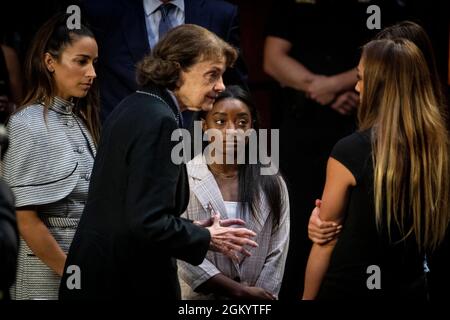 United States Senator Dianne Feinstein (Democrat of California), second from left, talks with former U.S. Olympic gymnast Aly Raisman, left, US Olympic gymnast Simone Biles, second from right, and NCAA and world champion gymnast Maggie Nichols, right, following a Senate Committee on the Judiciary hearing to examine the Inspector General's report on the Federal Bureau of Investigation's handling of the Larry Nassar investigation in the Hart Senate Office Building in Washington, DC, Wednesday, September 15, 2021. Credit: Rod Lamkey/CNP Stock Photo