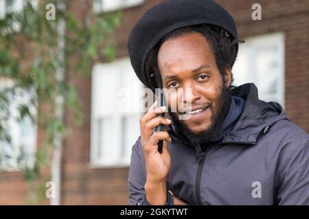 Black man talking on the mobile phone London England Stock Photo
